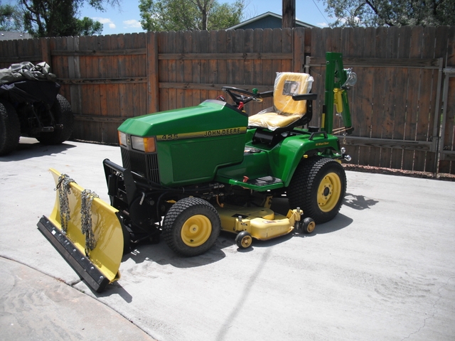 Image of John Deere 425 lawn tractor with snowplow attachment