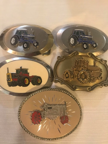 Tractor belt clearance buckles